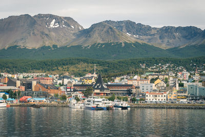 View of townscape by mountains against sky