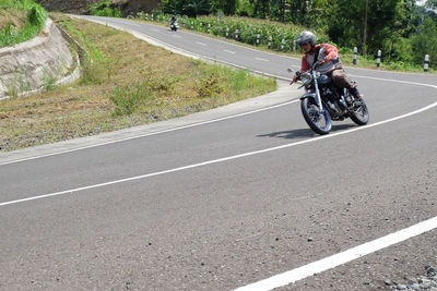 Man riding bicycle on road