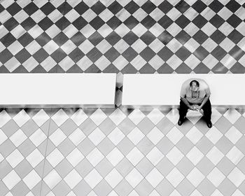 High angle view of man sitting on bench