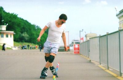 Man roller skating on road