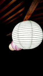 Low angle view of illuminated light bulbs hanging from ceiling