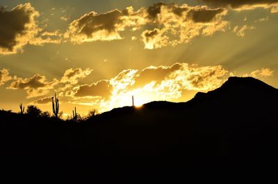 Scenic view of silhouette mountains against sky during sunset