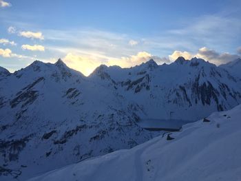 Scenic view of snow covered mountains against sky