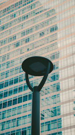 Low angle view of street light against building
