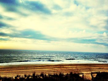 Scenic view of sea against cloudy sky