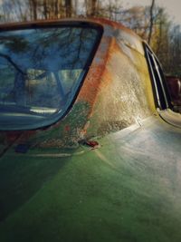 Close-up of reflection on side-view mirror of car