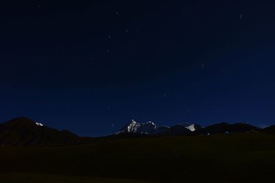 Scenic view of mountains against clear sky at night