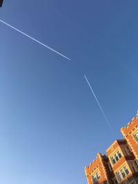 Low angle view of building against clear blue sky