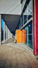 Empty footpath by building in city