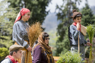 Rear view of people looking at camera