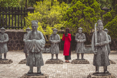 Rear view of woman standing against built structures