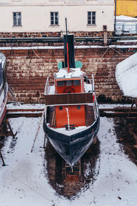 Boat moored in snow