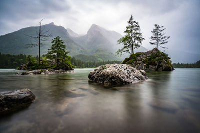 Scenic view of rocks in water against sky