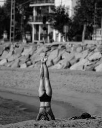 Woman with arms raised on beach