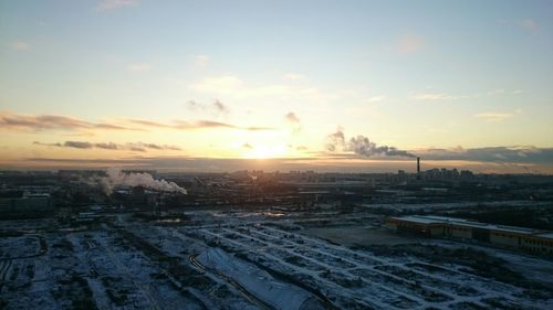 Scenic view of snow covered landscape at sunset