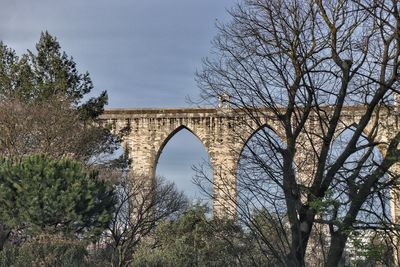 Low angle view of arch bridge against sky