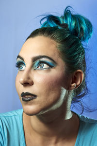 Close-up portrait of young woman looking away