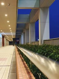 Illuminated railroad station platform in modern building