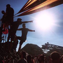 Silhouette of people standing against sky