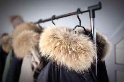 Close-up of winterjackets hanging on clothesline