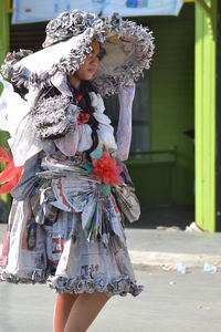 Rear view of woman with umbrella standing outdoors