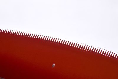 Close-up of red umbrella against clear sky