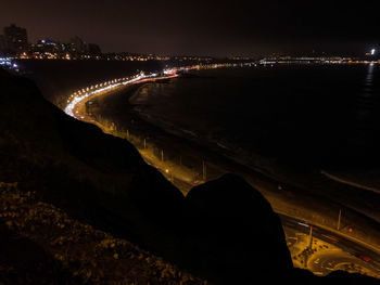 Aerial view of illuminated city at night