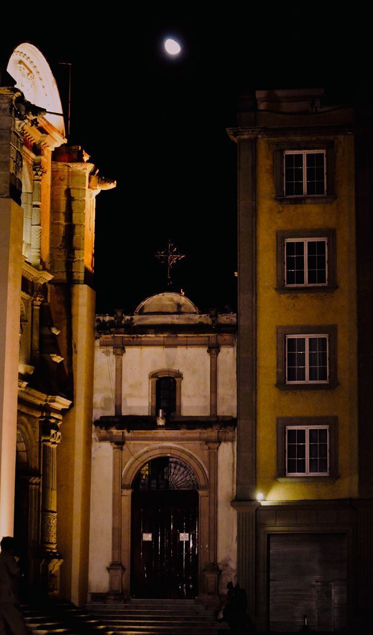 LOW ANGLE VIEW OF ILLUMINATED BUILDINGS AGAINST SKY AT NIGHT