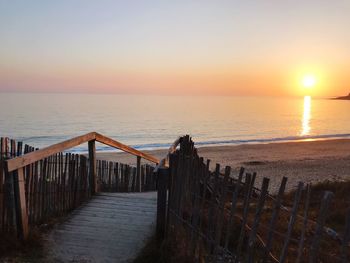 Scenic view of sea against clear sky during sunset