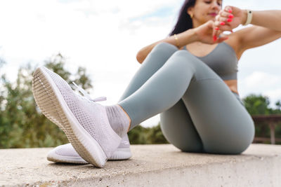 Low section of woman sitting outdoors