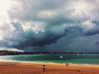 View of beach against cloudy sky