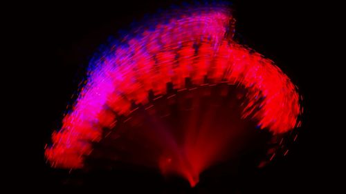 Low angle view of illuminated ferris wheel