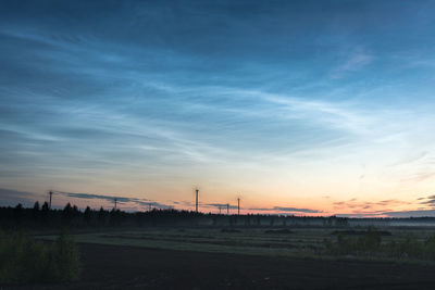 Scenic view of silhouette field against sky during sunset