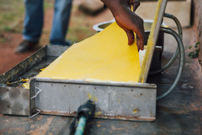 Close-up of man working on metal