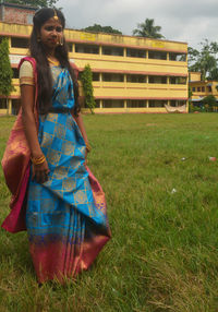 Young woman standing on field
