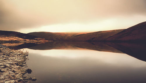Scenic view of lake against sky during sunset