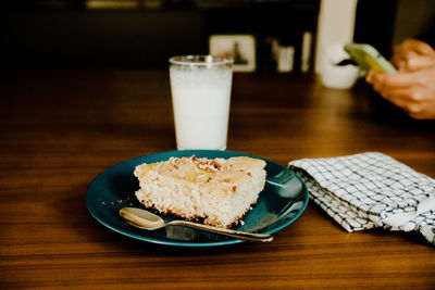 Midsection of woman having breakfast on table