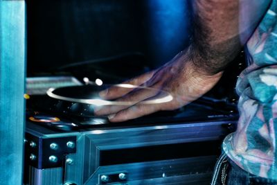 Cropped image of dj mixing records at turntables