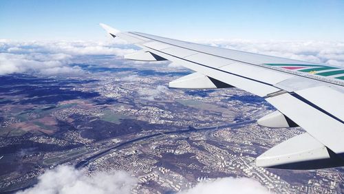 Aerial view of aircraft wing against sky