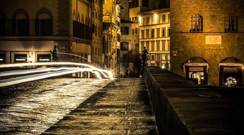 Walkway in city at night