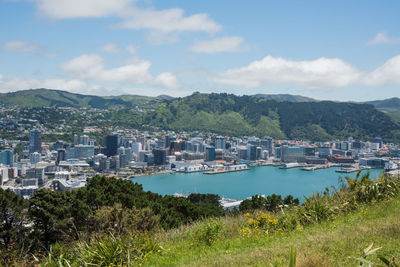 Scenic view of river amidst buildings against sky