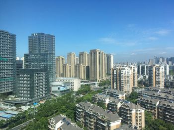 Modern buildings in city against sky