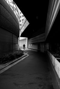 Rear view of man walking in tunnel