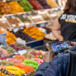 Midsection of man having food at market stall