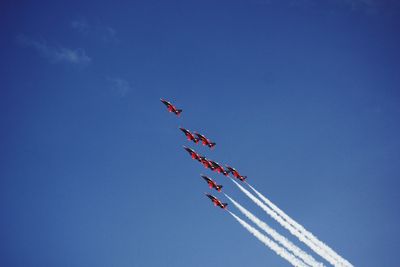 Low angle view of airshow against sky