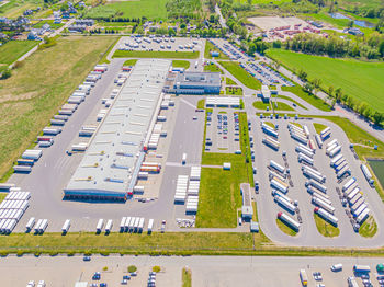 Aerial shot of industrial loading area where many trucks are unloading merchandis