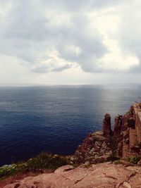 Scenic view of sea against cloudy sky