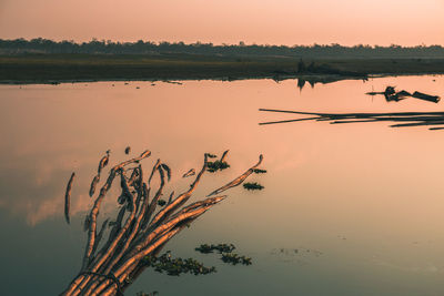 Scenic view of lake against sky during sunset