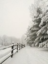 Scenic view of snow covered road against clear sky