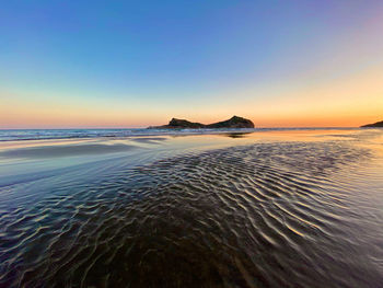 Scenic view of sea against clear sky during sunset